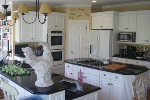 Beautiful Kitchen with White appliances and cabinets