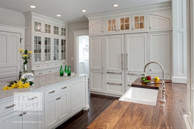 A traditional kitchen by Drury Designs with white cabinets, walls, and ceilings.