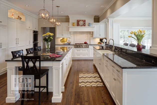 Traditional kitchen design with black counters and white cabinets by Drury Design