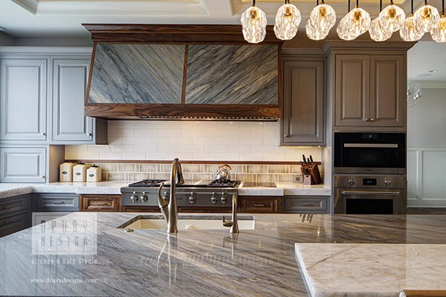 Transitional kitchen design with gran countertops and cabinets by Drury Design