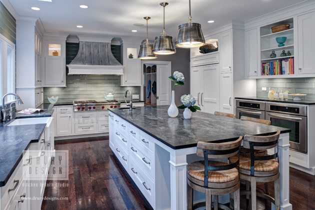 Transitional kitchen design with black counters and white cabinets and double oven by Drury Design